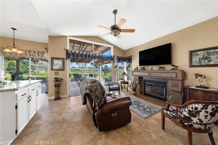The family room has a customized fireplace and a sliding door to the patio.