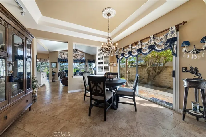 Your formal dining room with a sliding door to a side patio.   The dining chandelier does not convey.