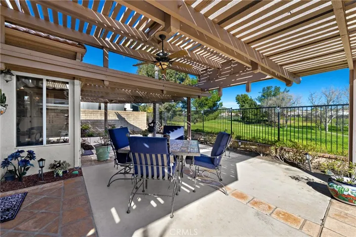 Your large patio wraps around the side and back of the home and is ideal for parties.  Note the tile accents and sweeping golf course view.