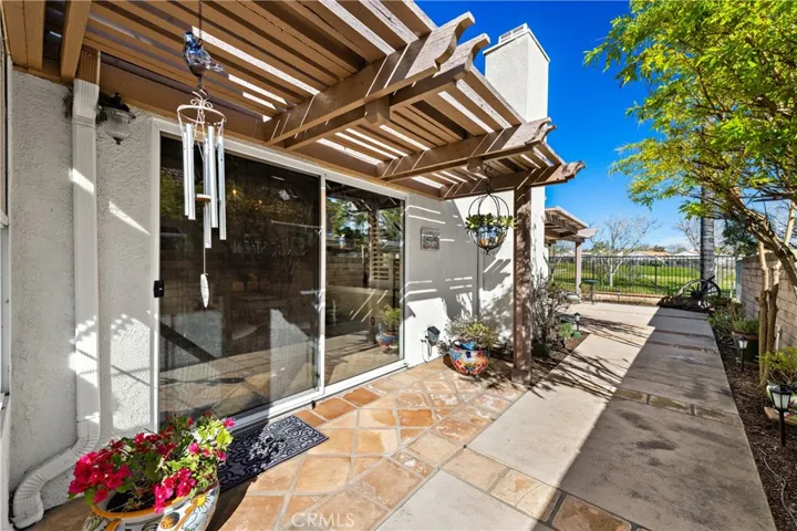Side patio off the dining room leads around the home to the large back patio.