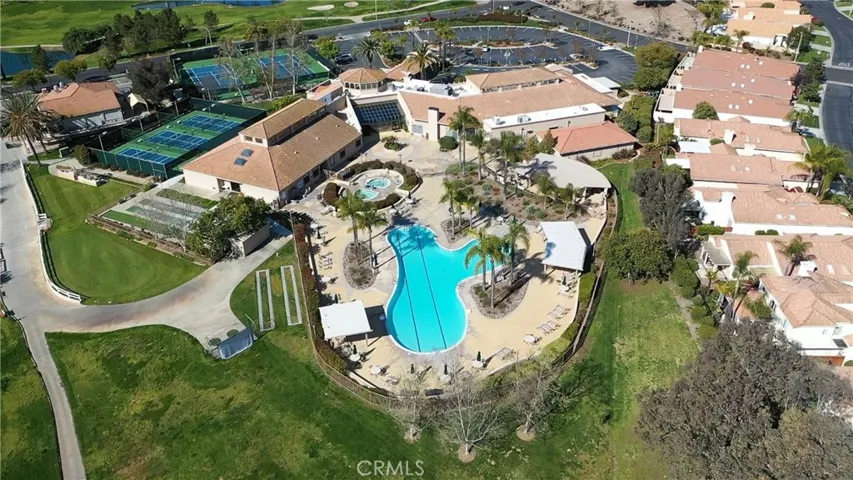 Aerial view of the clubhouse, sports courts, pool and spas.