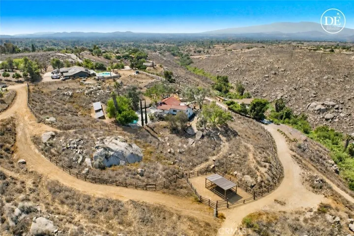 AI digital photo to show how the property could be fenced with a horse corral & stable in there
