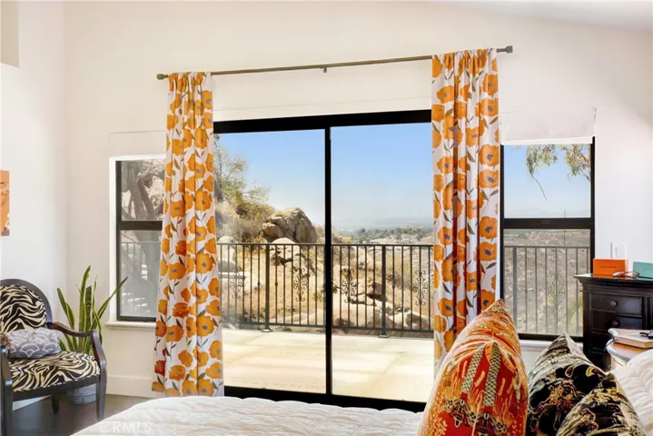 Master bedroom sliding doors leading to balcony
