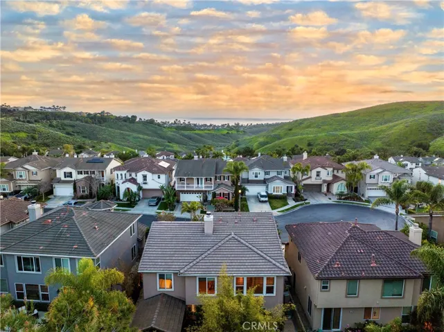 View of the valley beyond, back of the house in front center, at sunset.