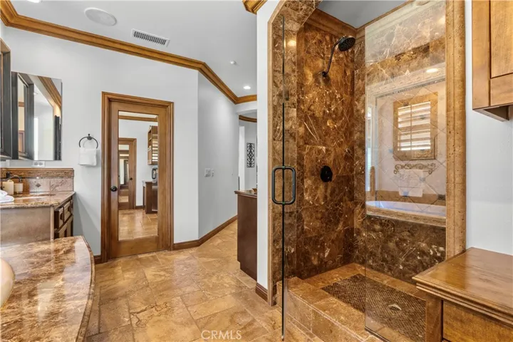 Reverse view of the Master Bathroom with shower and his/hers closet pictured.