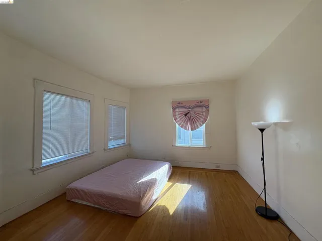 Bedroom with baseboards and light wood-type flooring