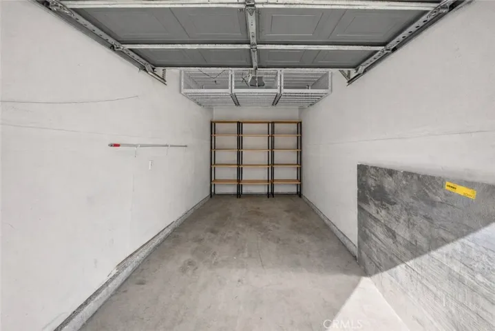 Photo was edited removing storage and adding shelving and overhead storage