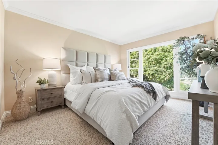Primary Bedroom has large windows, crown moulding, closet, and an attached en suite!