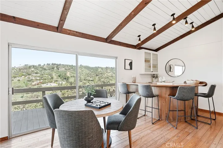 Wood flooring, bar area, back deck, and tons of natural light!
