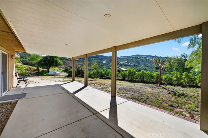 overed Outdoor Living Area – Generous concrete patio with overhead covering provides the perfect setting for gatherings, complete with tranquil countryside surroundings.