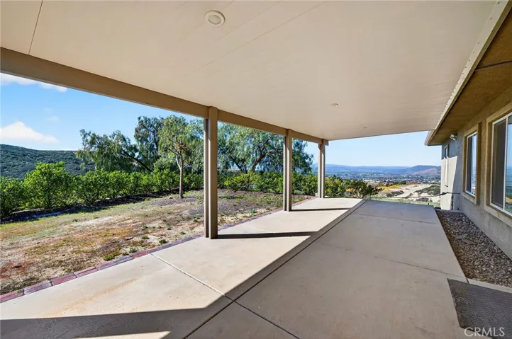 39475 Bruce Ln This covered patio offers year-round outdoor living with ample space for dining, lounging, and entertaining while enjoying scenic hillside views.