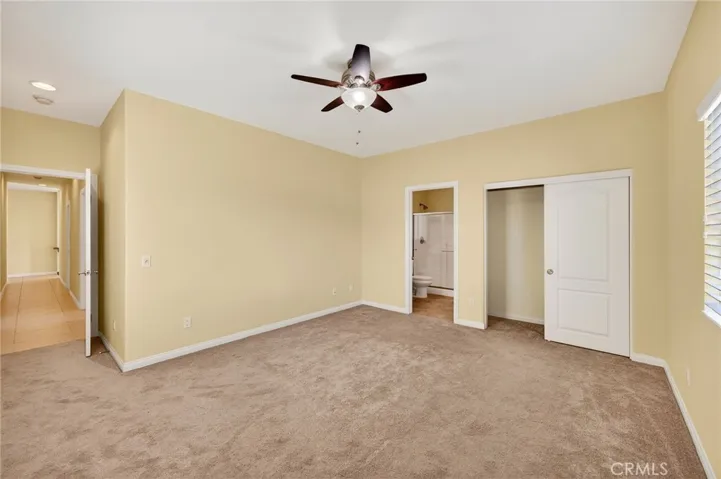 39475 Bruce Ln. front bedroom offers carpet, neutral tones, and a ceiling fan for added comfort, with direct access to the in-suite bathroom and ample closet space.