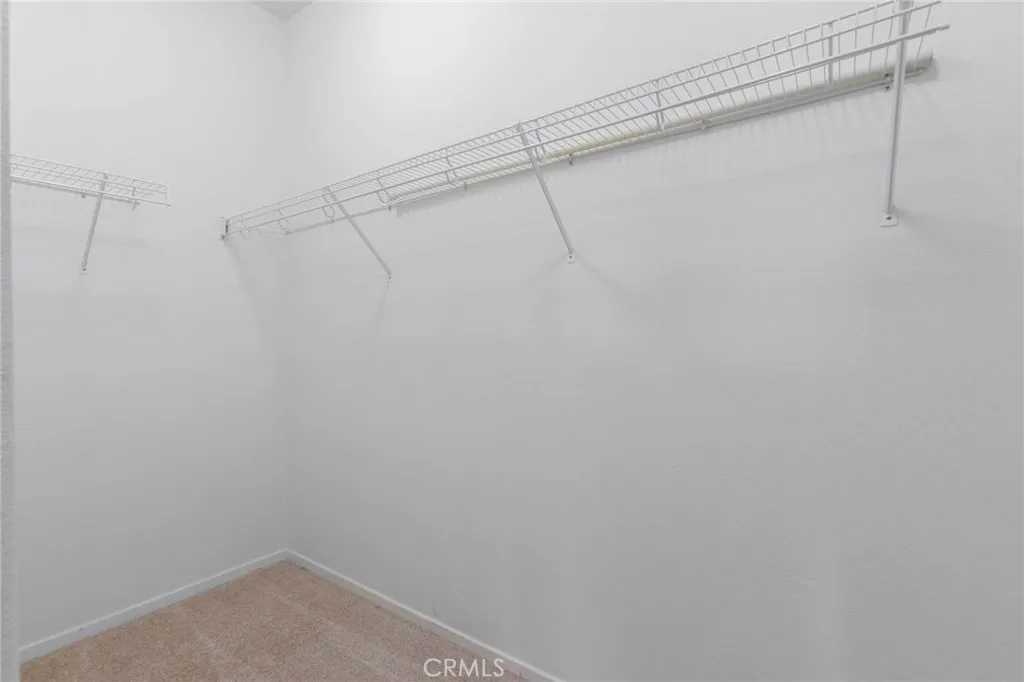 Primary bedroom walk in closet