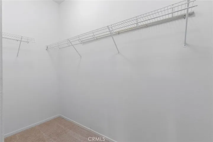 Primary bedroom walk in closet