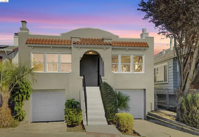 Mediterranean / spanish-style house featuring stucco siding, a chimney, a tile roof, a garage, and driveway