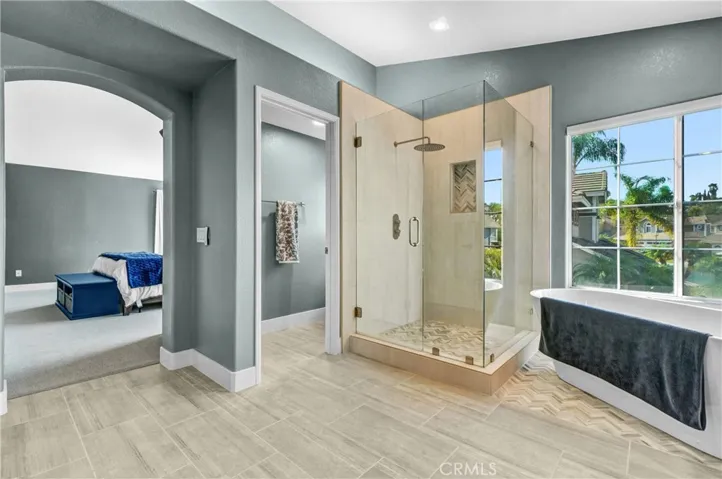 Oversized shower with upgraded tile, new class enclosure and fixtures.
