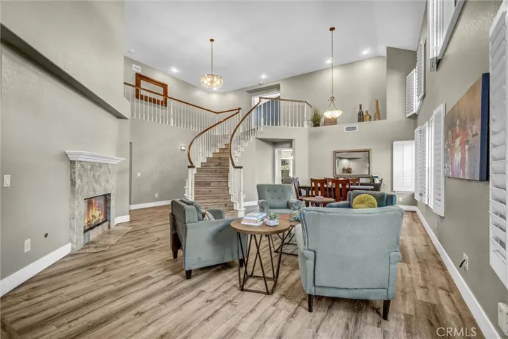 Enter into the formal living room with fireplace and opened to formal dining area