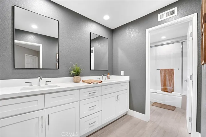 Double sinks and private shower/ tub room connected.