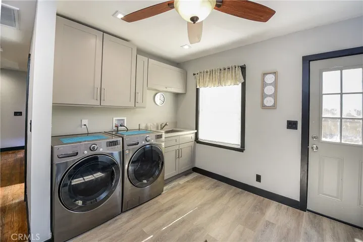 OVERSIZED laundry room/ mudroom. Sink, fan, separate entry, fan, great recessed lighting, vinyl flooring and plenty of room to preplan, organize and prepare for the week.