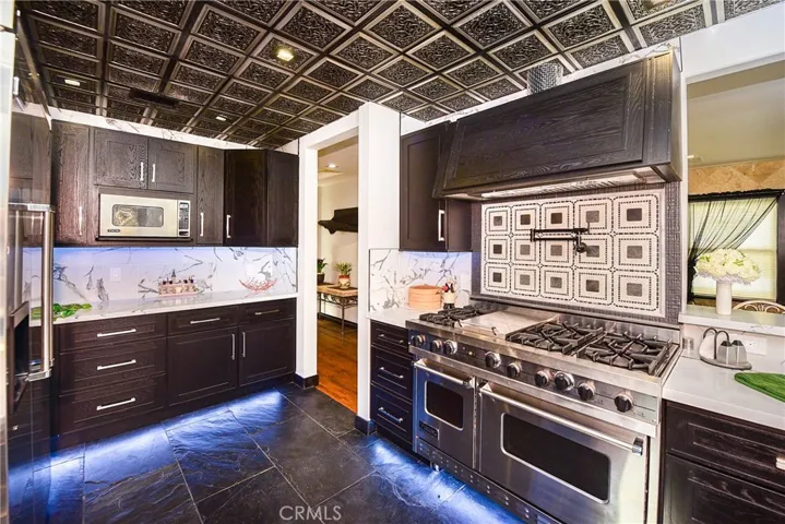 Custom chef's kitchen, Viking appliances, custom ceiling, quartz with waterfall edge, under cabinet and kicktoe lighting, pot filler.