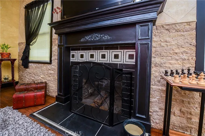Gorgeous custom fireplace. Wood, tile and stone details with installed tv above.