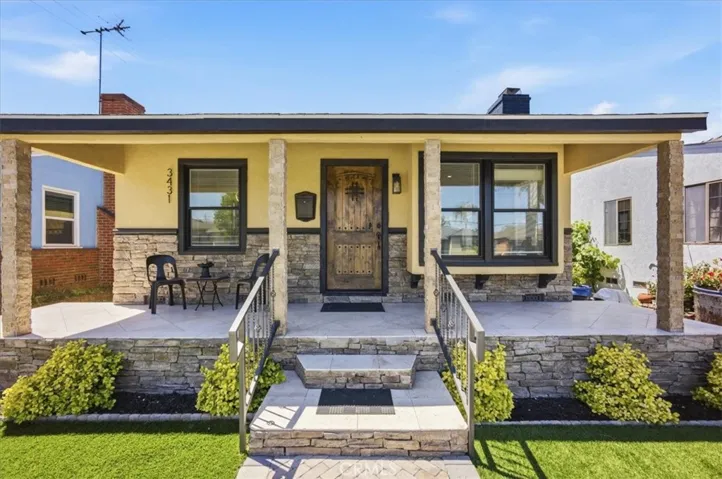 So many beautiful details, from the large porch to the custom door, decorative stone and endless upgrades