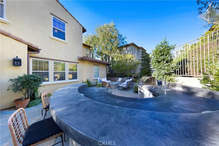 Generously sized built in bar with counter for seating and barbecue