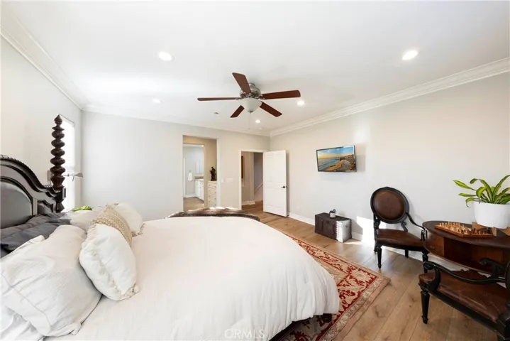 Light and bright primary suite with ceiling fan