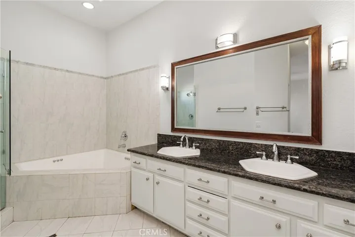 Private primary bath with dual-sink vanity and generous counter space