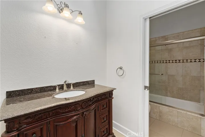 Additional full bathroom with spacious vanity and clean finishes