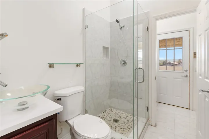 Secondary bath with walk-in shower and spacious vanity area