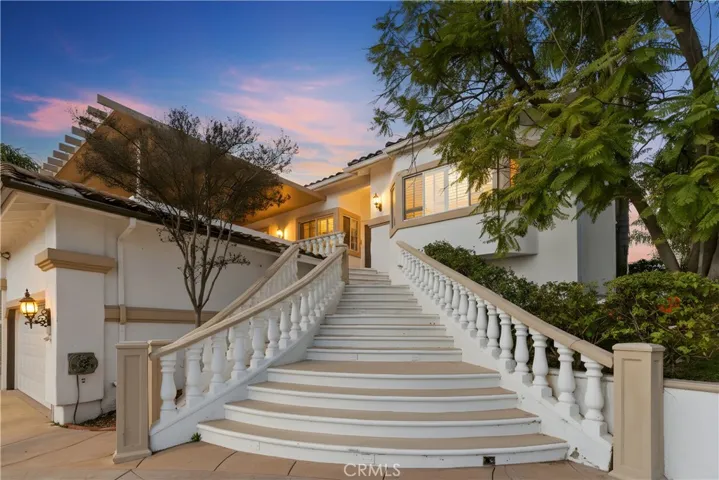 Welcoming front entry with grand stairs and charming approach