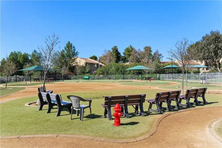 Spacious community grassy area with picnic tables, perfect for outdoor gatherings and lakeside enjoyment