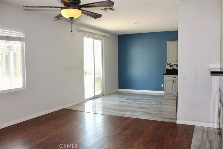 Family room with fireplace opens up to kitchen