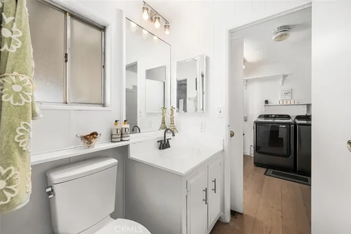 Guest bathroom features access to laundry