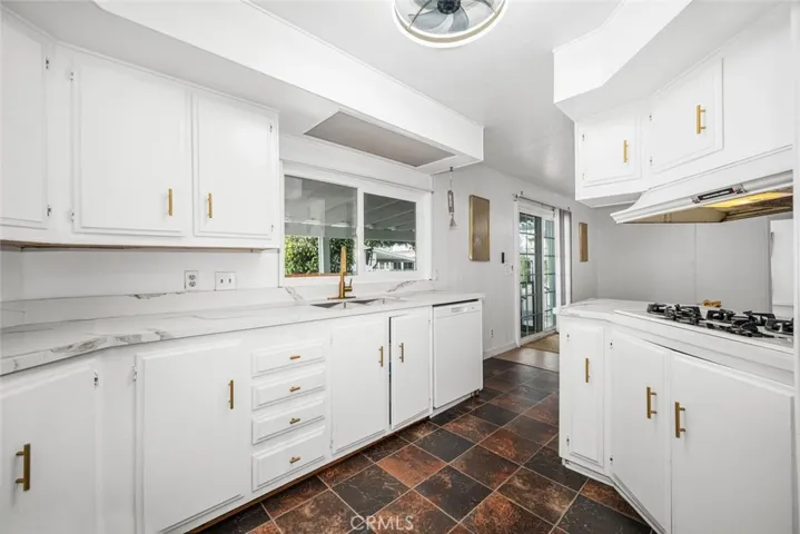Kitchen features gorgeous Quartz countertops & storage galore