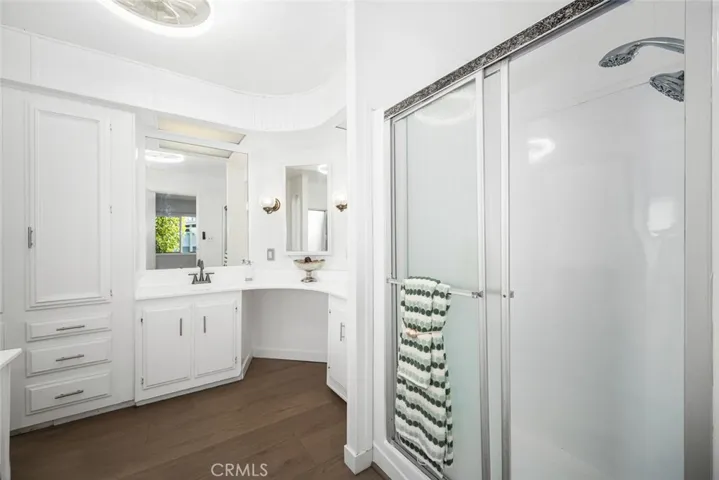 Primary bathroom features dual sinks, soaking tup and walk-in shower