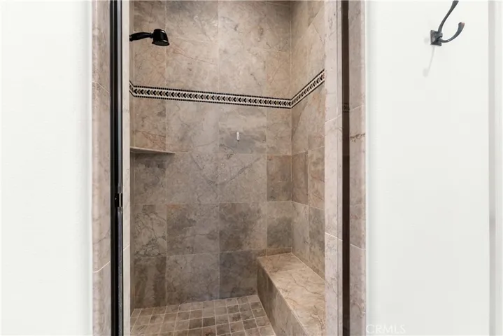 Beautiful shower with glass door, in primary bath.