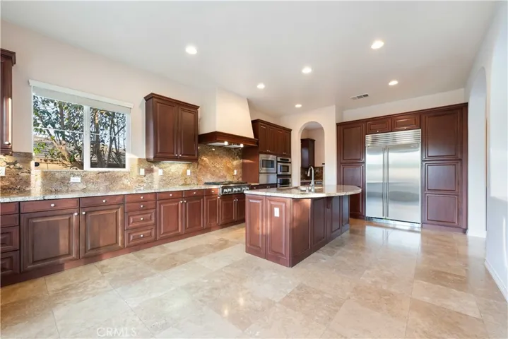 Gorgeous kitchen with loads of countertop & cabinet space. Sub Zero Refrigerator & freezer. It is sure to impress your friends.
