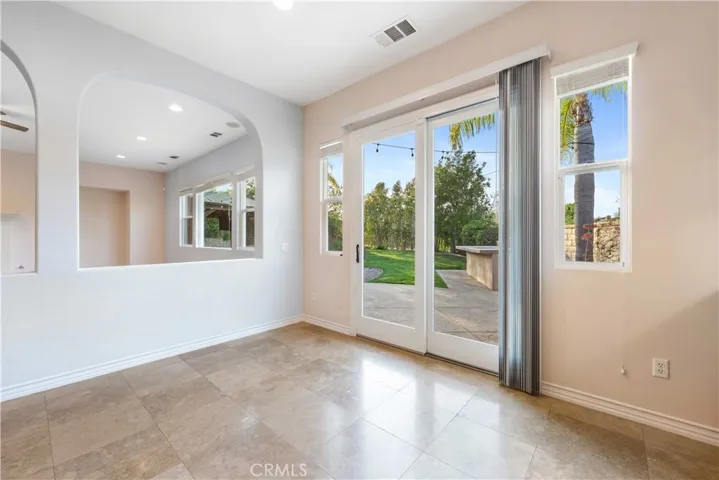 Breakfast area, open to the great room, with a glass slider & a view of the backyard.