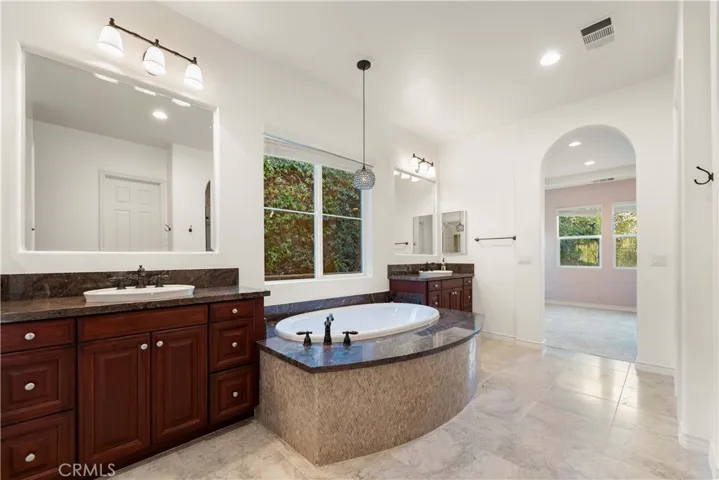 Primary bath with double sinks, soaking tub & a beautiful stall shower