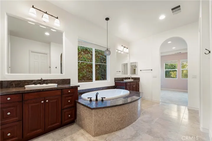 Primary bath with double sinks, soaking tub & a beautiful stall shower