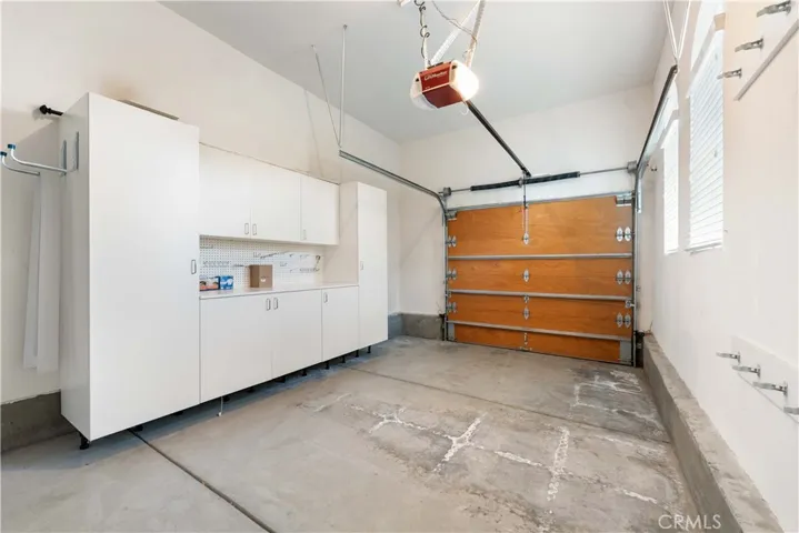 Direct access single attached garage with loads of storage & an auto opener.