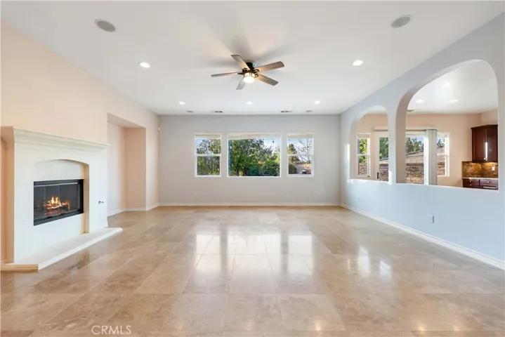 Large, open great room w/fireplace, view of the backyard & kitchen
