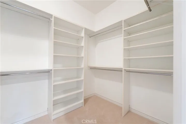 2nd walk-in closet with organizers in primary bedroom