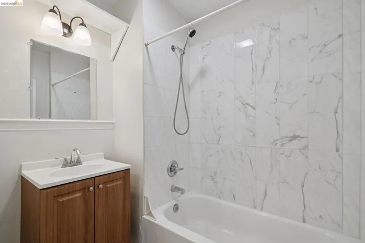 Bathroom featuring vanity and bathing tub / shower combination