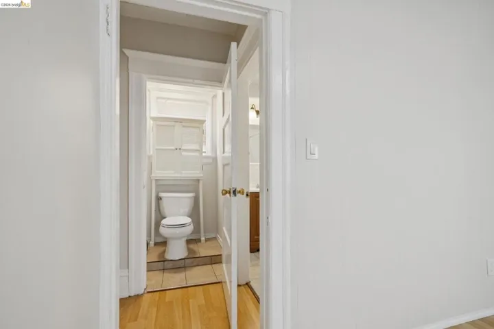 Bathroom with light wood finished floors and toilet
