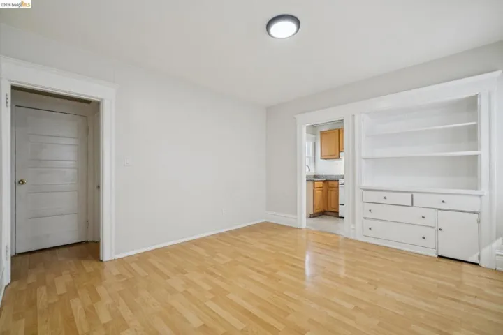 Unfurnished bedroom with light wood-type flooring and connected bathroom