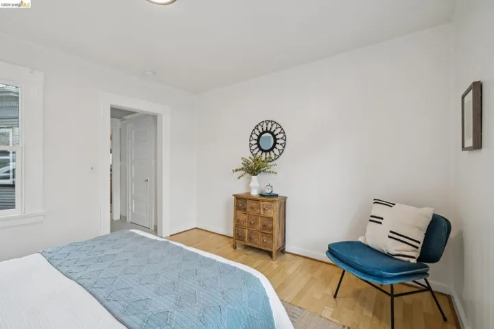 Bedroom with wood finished floors and baseboards