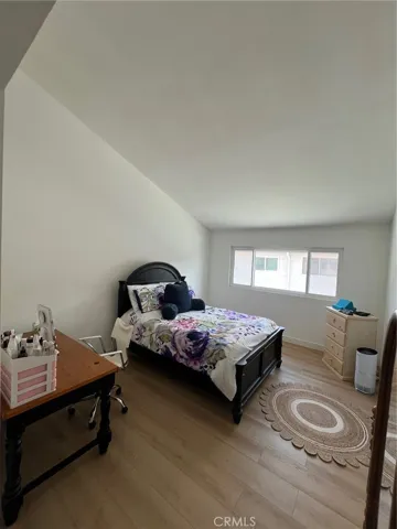 Primary bedroom with vaulted ceiling
